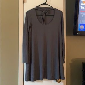 Grey dress, with tie around the neck.